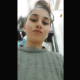 A brunette girl records herself shitting while sitting on a toilet. Action is seen from an under the ass perspective. Vertical format video. Over a minute.